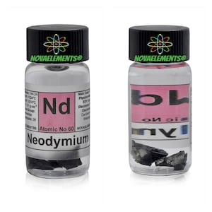 May include: A small glass bottle containing a sample of neodymium, a silvery-white rare earth metal. The bottle has a black label with the text "NOVAELEMENTS®", "Nd", "Atomic No 60", and "Neodymium".
