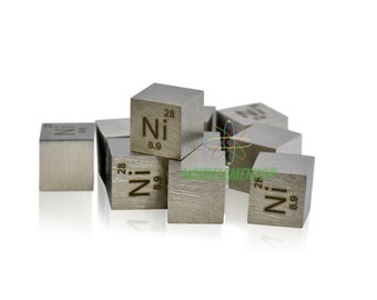 May include: A group of small, silver-colored cubes, each with the chemical symbol "Ni" and the atomic number "28" engraved on one side. The cubes are arranged in a loose pile on a white background.