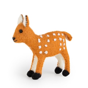 May include: A handmade orange felt deer figure with white spots and black hooves. The deer has white detailing on its legs and ears. This decorative item is suitable for home decor or as a child's toy.