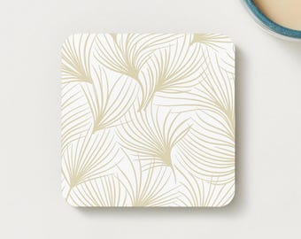 Sottobicchiere minimalista con piuma dorata.