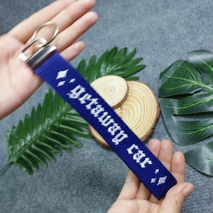 May include: A blue key chain with a white embroidered inscription that reads "gateway car".