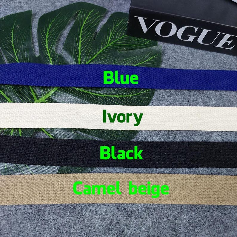 May include: Four different colors of cotton webbing, from left to right: blue, ivory, black, and camel beige.
