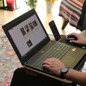 sitting on the couch using a computer