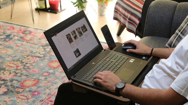 sitting on the couch using a computer