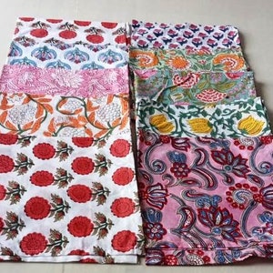 May include: A set of ten colorful fabric napkins with floral patterns. The napkins are made of cotton and are perfect for adding a touch of elegance to any table setting.