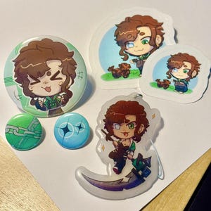 May include: A collection of anime-style merchandise including a large circular pin, two small circular pins, two die-cut stickers, and a clear acrylic charm. The items feature a brown-haired character in a green outfit and a small brown dog.