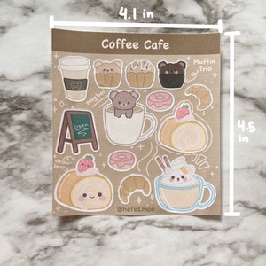 May include: A sheet of stickers featuring a coffee cafe theme with illustrations of coffee cups, pastries, and bears. The stickers are 4.1 inches wide and 4.5 inches tall. The text "Coffee Cafe" is at the top of the sheet. The text "Muffin Trio" is at the top right of the sheet. The text "mug boi" is at the top left of the sheet. The text "Open" is on a sign at the bottom left of the sheet. The text "straw-berry" is at the bottom left of the sheet. The text "@heres.moo" is at the bottom right of the sheet.