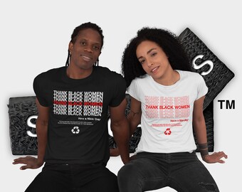 May include: Two people wearing black and white t-shirts with the text "THANK BLACK WOMEN" repeated in red and white. The text is printed on a black t-shirt and a white t-shirt. The people are sitting on a black and white textured surface. The text "Have a Nice Day" is printed below the repeated text on the t-shirts.