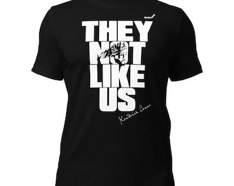 May include: Black t-shirt with white text that reads "They Not Like Us" with a silhouette of Kendrick Lamar's head and his signature below the text.