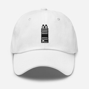 May include: White baseball cap with a black and white graphic of a walkie talkie on the front.