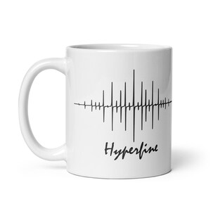 May include: White ceramic coffee mug with a black graphic of a sound wave and the text "Hyperline" printed on the front.