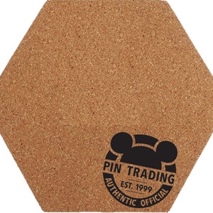 May include: A hexagonal cork board with a black and white logo that says "Pin Trading Est. 1999 Authentic Official".
