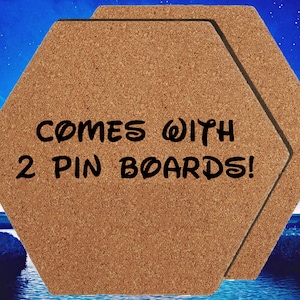 May include: Two brown cork hexagon-shaped pin boards with the text "COMES WITH 2 PIN BOARDS!" printed in black.