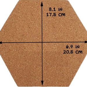 May include: A hexagonal cork board with measurements in inches and centimeters. The board is 8.1 inches (17.5 cm) wide and 6.9 inches (20.5 cm) long.