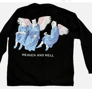 May include: Black long-sleeved shirt featuring a graphic of three cat-like figures with angel wings, dressed in blue robes. The text "HEAVEN AND HELL" is printed below the figures. The shirt has a classic, casual design.