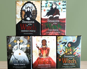 May include: Five different oracle card decks with colorful illustrations of women and nature. Each deck has a title that includes "Seasons of the Witch" and the name of a specific pagan holiday: Samhain, Yule, Imbolc, Beltane, and Mabon.