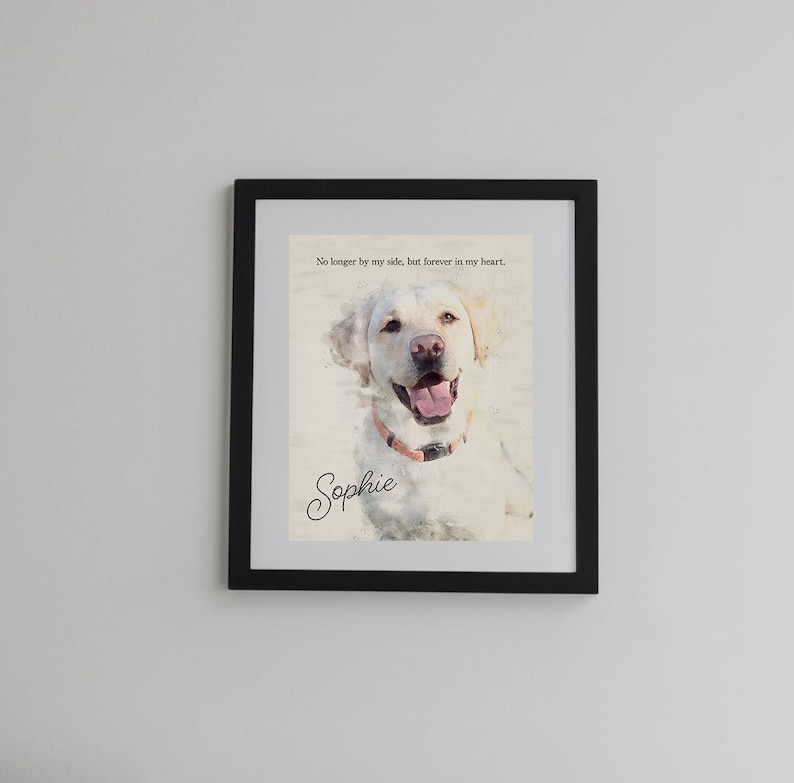 May include: Framed watercolor print of a smiling yellow Labrador Retriever wearing a pink collar. The print includes the text "No longer by my side, but forever in my heart." and the name "Sophie" in cursive.
