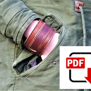 May include: A brown leather cuff bracelet with stitching detail. The bracelet is worn on a person's wrist, with the cuff overlapping the person's hand.