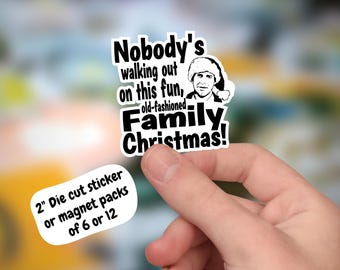 May include: A black and white die-cut sticker with the text "Nobody's walking out on this fun, old-fashioned Family Christmas!" and a cartoon image of a man wearing a Santa hat. The sticker is 2 inches in diameter and is available in packs of 6 or 12.