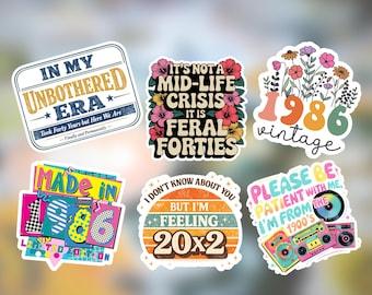 May include: Six rectangular and shaped vinyl stickers featuring colorful retro designs and text including In My Unbothered Era, It's Not A Mid-Life Crisis It Is Feral Forties, 1986 vintage with flowers, Made In 1986, Feeling 20x2, and Please Be Patient With Me.