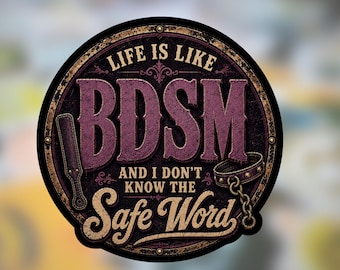 May include: A circular sticker with a dark purple and black background featuring the text LIFE IS LIKE BDSM AND I DON'T KNOW THE Safe Word. The design includes a brown leather paddle on the left and a brown leather collar with a chain on the right.