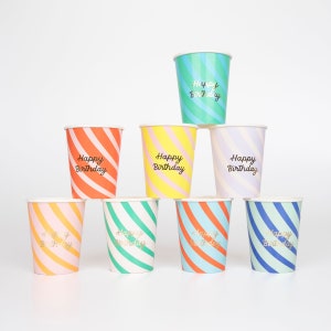 May include: Set of eight colorful striped paper cups with gold lettering that says "Happy Birthday".