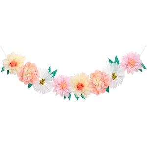 May include: A garland of paper flowers in shades of pink, peach, and white with green leaves. The flowers are arranged in a semi-circle shape.