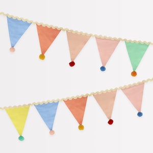 May include: A colorful bunting with alternating pastel colored triangle flags and pom poms. The bunting is strung on a white scalloped edge ribbon.