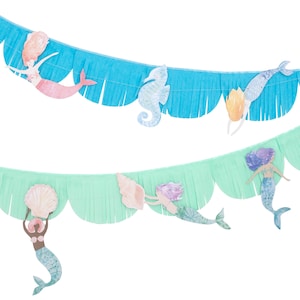 May include: Decorative mermaid-themed banner with blue and green fringed paper. The banner features cut-out mermaids, seahorses, and seashells in pastel colors. Perfect for a mermaid-themed party or room decor.