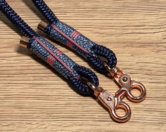 May include: A navy blue rope leash with pink and blue accents and rose gold metal clasps.