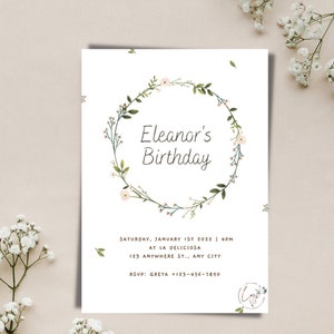May include: A white invitation with a floral wreath border. The text reads "Eleanor's Birthday" and includes details for a party on Saturday, January 1st, 2022 at 4pm at La Deliciosa, 123 Anywhere St., Any City. RSVP to Greta at +123-456-7890.