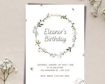 May include: A white invitation with a floral wreath border. The text reads "Eleanor's Birthday" and includes details for a party on Saturday, 1st January 2022 at 4pm at La Deliciosa, 123 Anywhere St., Any City. RSVP to Greta at +123-456-7890.
