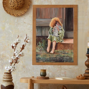 May include: A framed painting of a young girl in a green dress holding a white rabbit. The painting is set in a rustic outdoor setting with a wooden door and green grass.
