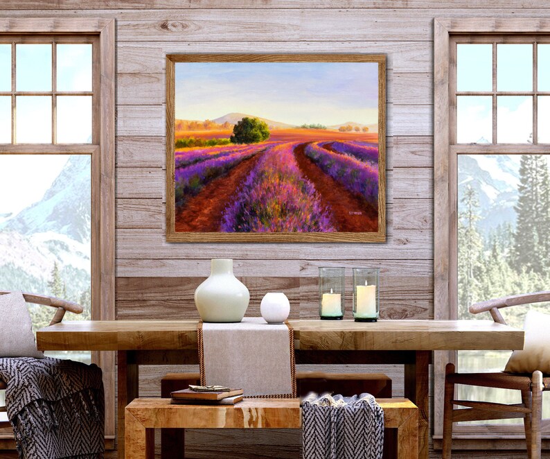 May include: A framed painting of a lavender field with a dirt road leading through the center. The field is a vibrant purple and the sky is a soft blue. The painting is hanging on a wooden wall with two windows on either side.
