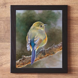 May include: A framed wall art print featuring a painting of a small bird with olive-green, yellow, and blue feathers perched on a textured brown tree branch. The bird is shown from behind, looking to the right. The frame is a simple black border.
