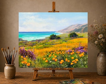 May include: An oil painting on a wooden easel depicting a coastal landscape with vibrant orange poppies and purple wildflowers in the foreground, rolling hills, and a turquoise ocean under a light blue sky, with paintbrushes and a palette nearby.