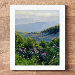 May include: A framed oil painting depicting a landscape with vibrant green bushes and clusters of pink flowers in the foreground, leading to rolling blue mountains in the distance under a soft sky. The signature STYNER is visible in the bottom left.