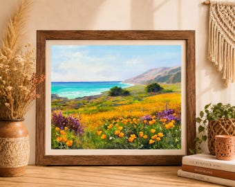 May include: A framed landscape painting depicting a coastal scene with vibrant orange poppies and purple wildflowers in the foreground, rolling green hills in the distance, and a bright turquoise ocean under a light blue sky with soft white clouds.