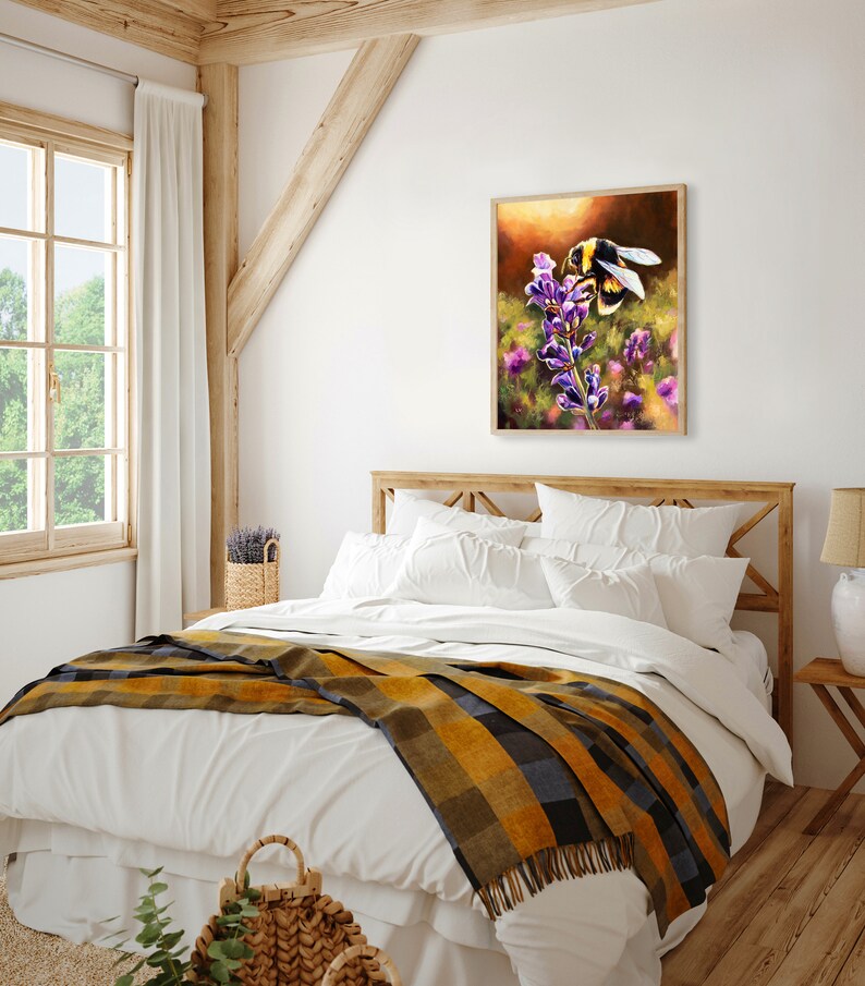 May include: A painting of a bumblebee pollinating a purple flower. The bee is in focus and the flower is blurred in the background. The painting is framed and hanging on a white wall in a bedroom.