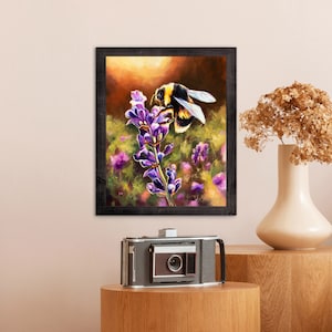 May include: A framed painting of a bumblebee pollinating a purple flower. The painting is set against a background of a field of flowers.