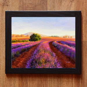 May include: A painting of a lavender field with a dirt road leading through it. The field is in bloom, with purple and pink flowers. The sky is blue and there are hills in the distance.