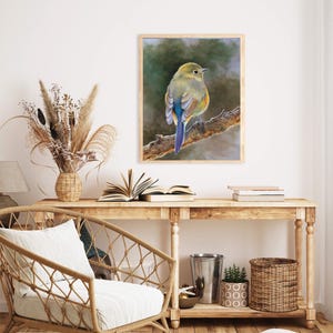May include: A framed wall art print featuring a painting of a small bird with olive green, yellow, and blue plumage perched on a textured brown tree branch against a soft, blurred, dark green and grey background.