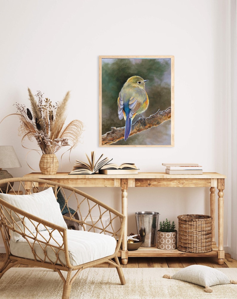 May include: A framed wall art print featuring a painting of a small bird with olive green, yellow, and blue plumage perched on a textured brown tree branch against a soft, blurred, dark green and grey background.