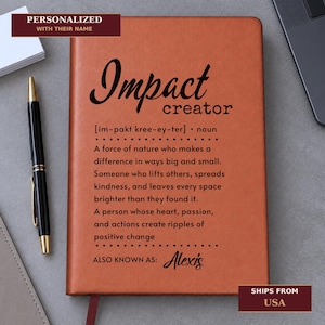 May include: A tan leather-effect notebook featuring the black printed text Impact creator, a phonetic pronunciation, and a definition describing a force of nature who makes a difference. The bottom includes the text ALSO KNOWN AS: Alexis in script.