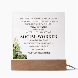 May include: A square acrylic plaque set in a rectangular light wood base. The plaque features dark text reading: FOR THE INVALUABLE KNOWLEDGE YOU SHARED, FOR YOUR DEDICATION, SUPPORT AND PATIENCE, THANK YOU! A TRULY AMAZING SOCIAL WORKER IS HARD TO FIND.