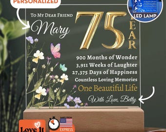 May include: A clear acrylic plaque on a wooden base featuring the text To My Dear Friend Mary 75 Year, 900 Months of Wonder, 3,911 Weeks of Laughter, 27,375 Days of Happiness, Countless Loving Memories, One Beautiful Life, With Love, Betty and floral art.