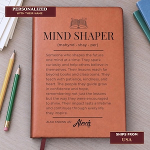 Peut inclure: Un carnet à couverture en cuir beige avec une illustration noire d'un livre ouvert, le texte MIND SHAPER, une transcription phonétique, un paragraphe descriptif sur le fait de façonner l'avenir et le texte ALSO KNOWN AS: Alexis.