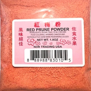 May include: A pink and white package of red prune powder with the text "Red Prune Powder" and "佐食水果" in black. The package also includes the ingredients, net weight, and a barcode.