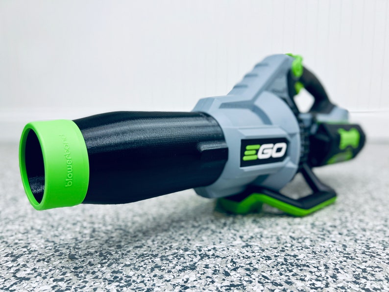 May include: A black and green leaf blower with the word "EGO" printed on the side. The blower has a green nozzle with the word "blower" printed on it.
