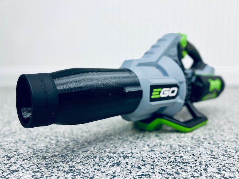 May include: A black and gray leaf blower with a green handle and the word "EGO" printed on the side. The blower has a black nozzle with the word "powerplex" printed on it.